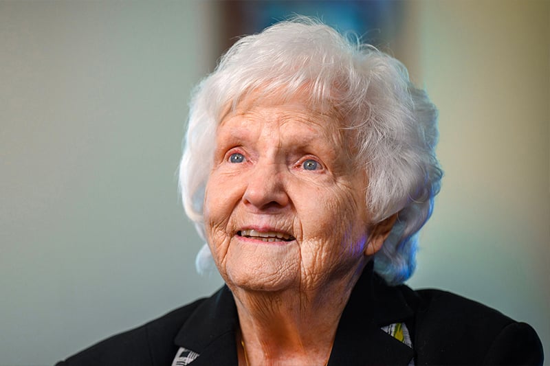 A portrait of Sister Rosemary Connelly, a white women with short white hair and bright blue eyes.