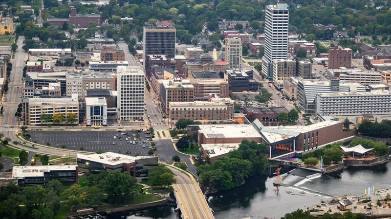 Aerial view of downtown South Bend, Indiana, featuring the St. Joseph River and the Century Center complex.