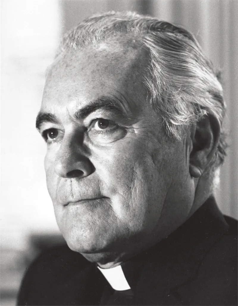 A black and white close-up portrait of Father Theodore Hesburgh, C.S.C., looking thoughtfully into the distance. He is wearing a black clerical shirt with a white tab collar.
