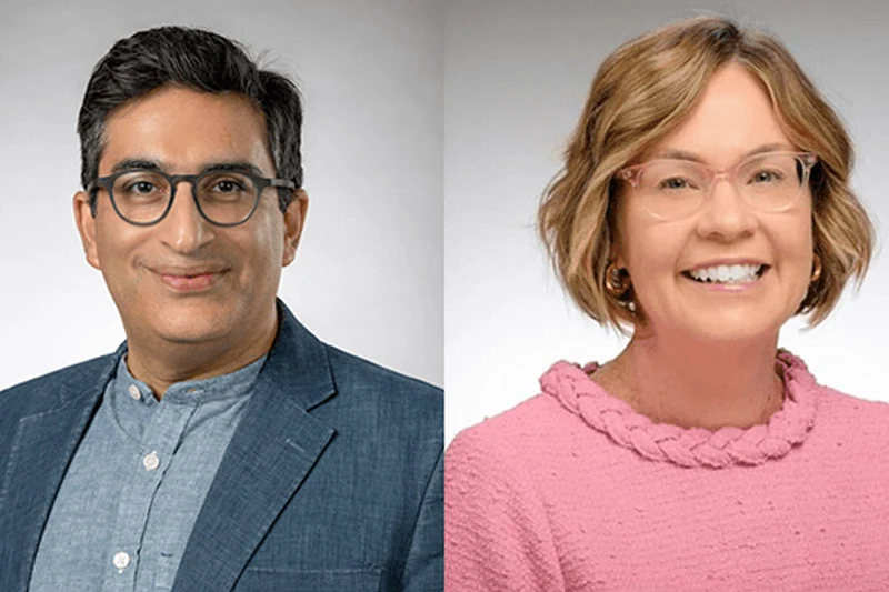Headshot of a smiling man with glasses, wearing a blue blazer, next to a smiling woman with pink glasses and a pink knit top.